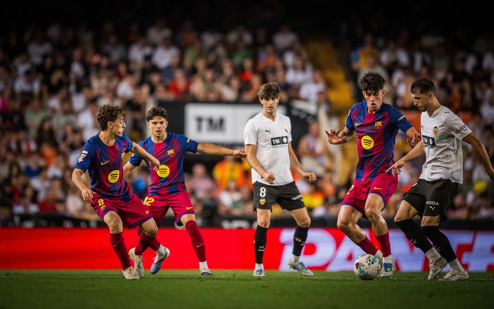 Barcelona and Valencia players contest a La Liga match