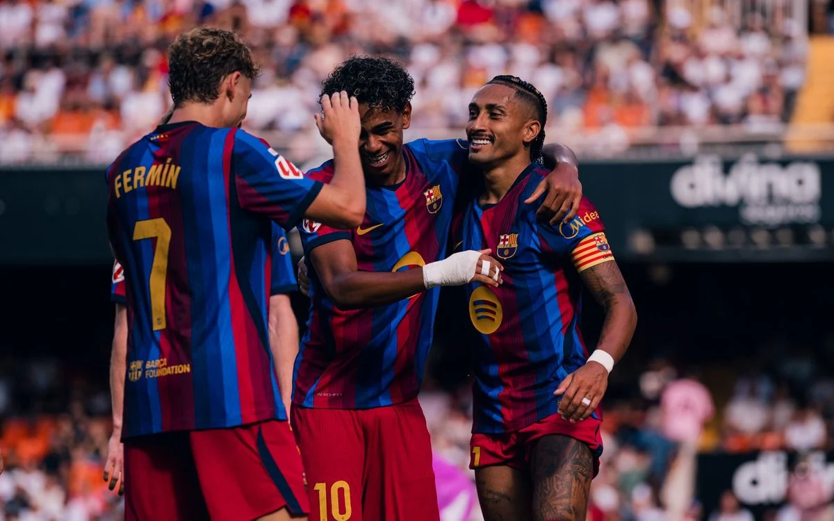 Barcelona players celebrate a goal during their 2026 league match at Valencia