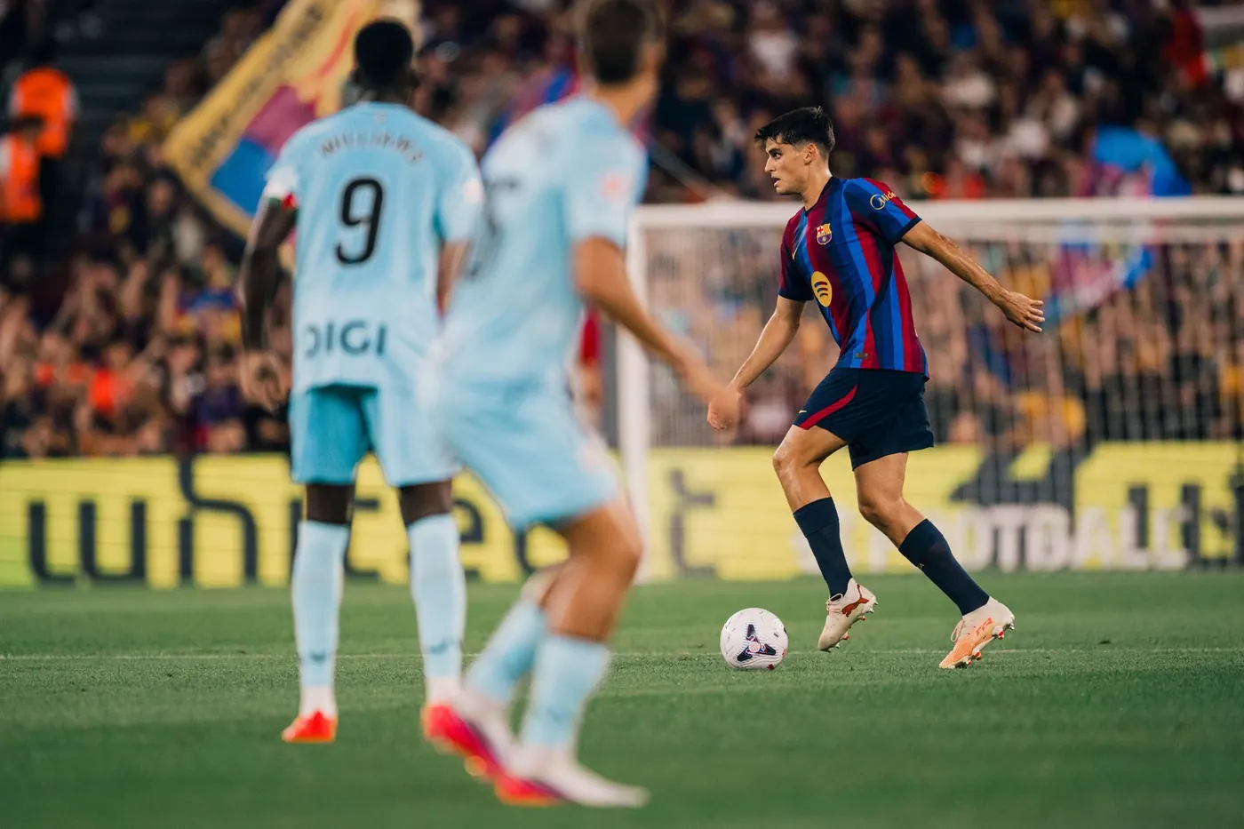 Pedri carries the ball for Barcelona against Athletic Club in a La Liga match