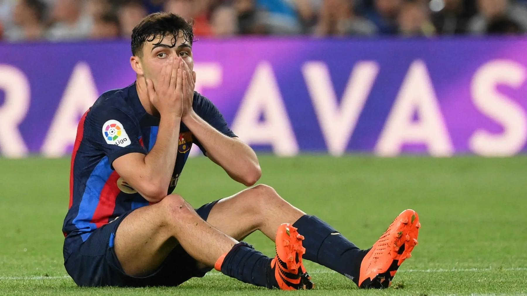 Barcelona midfielder Pedri seated on the pitch after a La Liga match