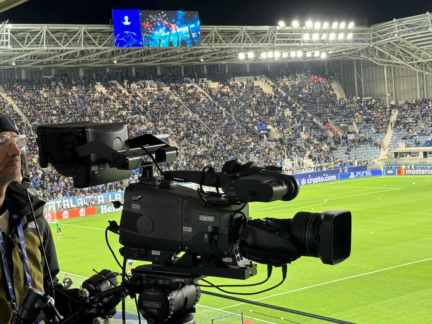 A television camera covering an elite European club match in a packed stadium
